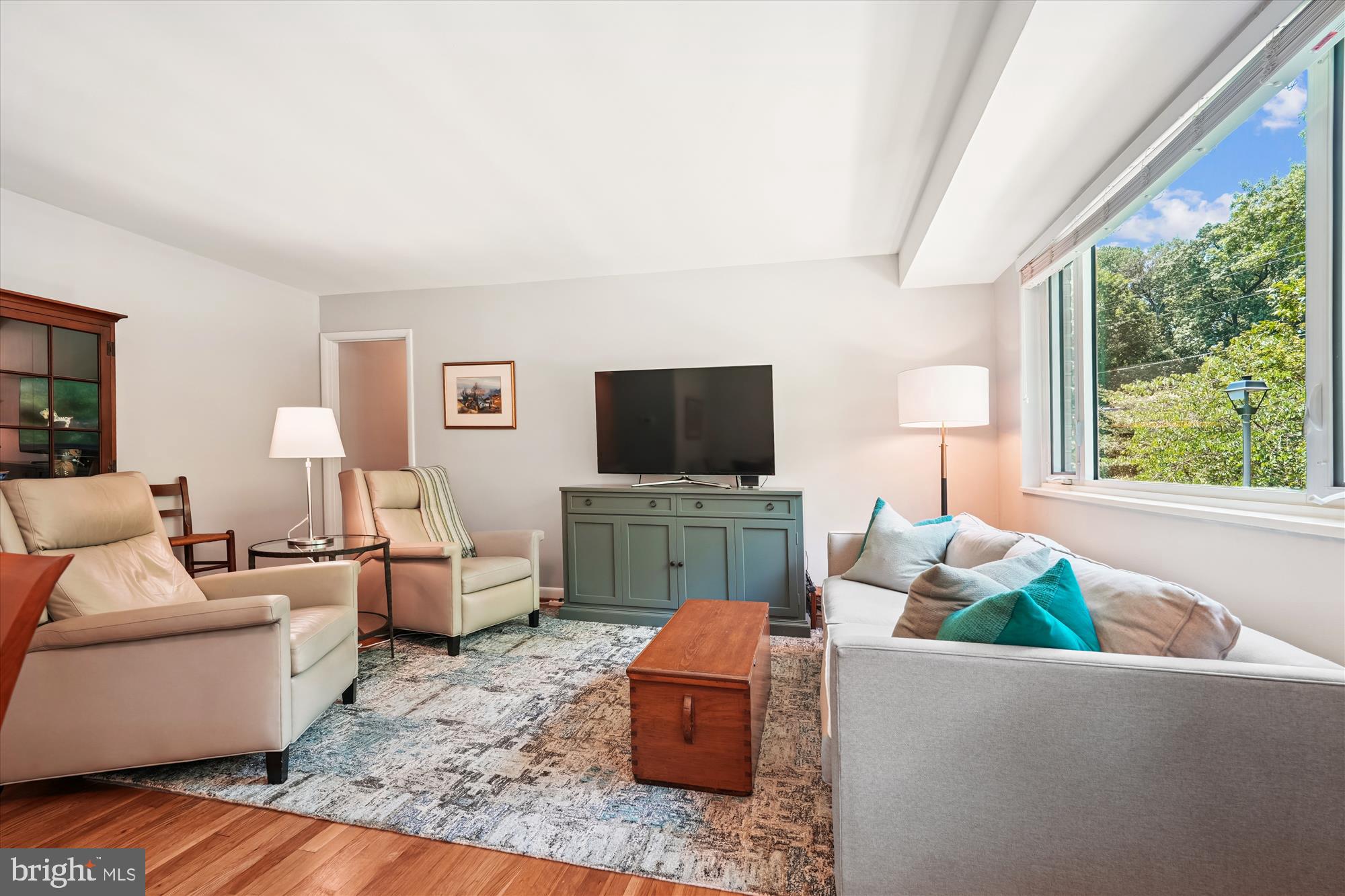 10427 Montrose Avenue, Unit 104 Bethesda, MD 20814 - Photo 8 of 37 a living room with furniture and a flat screen tv