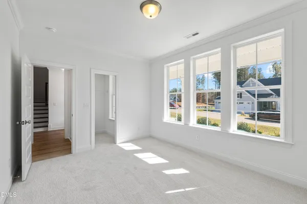 an empty room with windows and closet