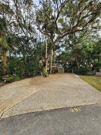 a view of backyard with seating space and wooden fence