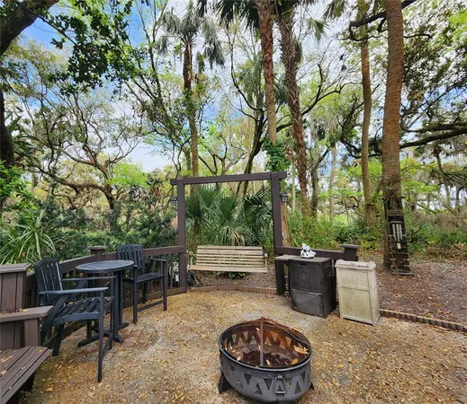 a view of backyard with swimming pool and outdoor seating