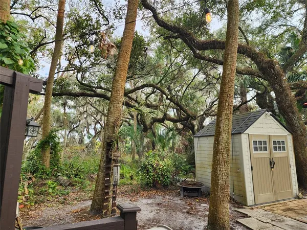 a view of a tables and chairs under an umbrella