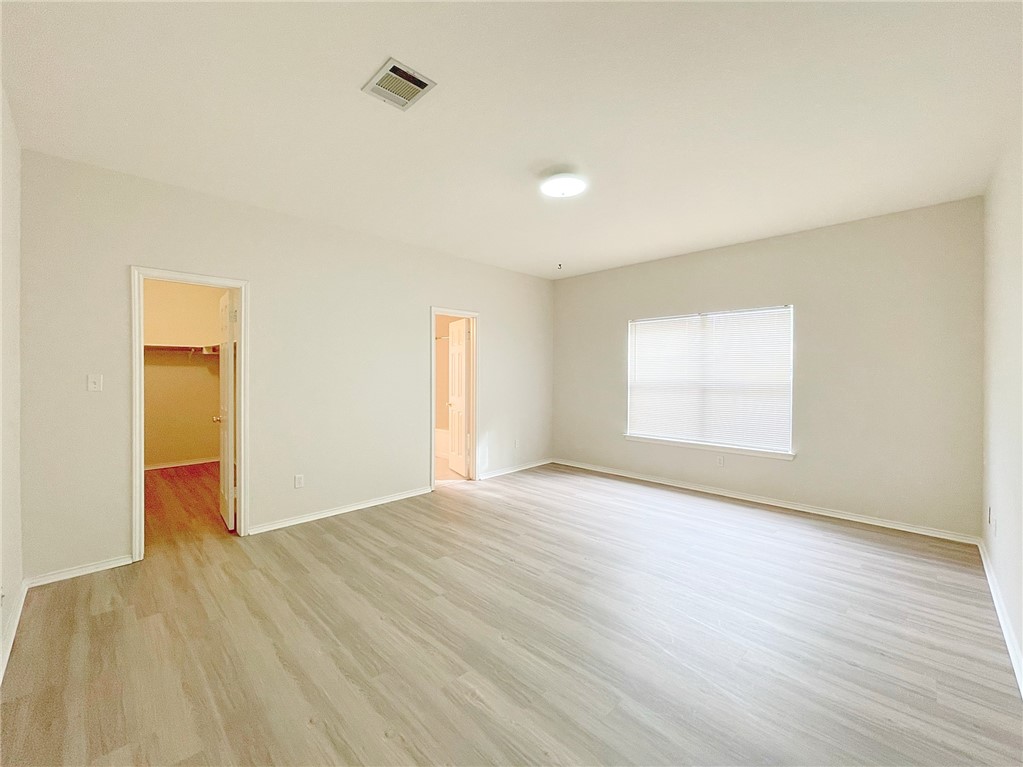 2211 Little Tree Bend Cedar Park, TX 78613 - Photo 11 of 23 an empty room with wooden floor and windows