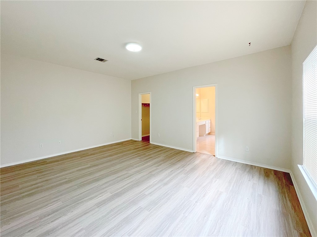 2211 Little Tree Bend Cedar Park, TX 78613 - Photo 12 of 23 a view of an empty room with wooden floor and a window