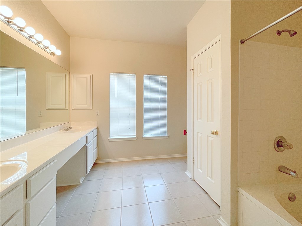 2211 Little Tree Bend Cedar Park, TX 78613 - Photo 14 of 23 a bathroom with a tub sink and mirror