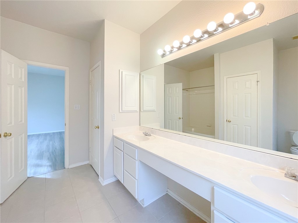 2211 Little Tree Bend Cedar Park, TX 78613 - Photo 15 of 23 a bathroom with a sink a large mirror and a shower