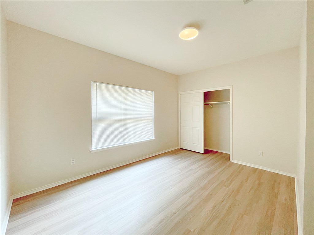 2211 Little Tree Bend Cedar Park, TX 78613 - Photo 17 of 23 an empty room with wooden floor and windows