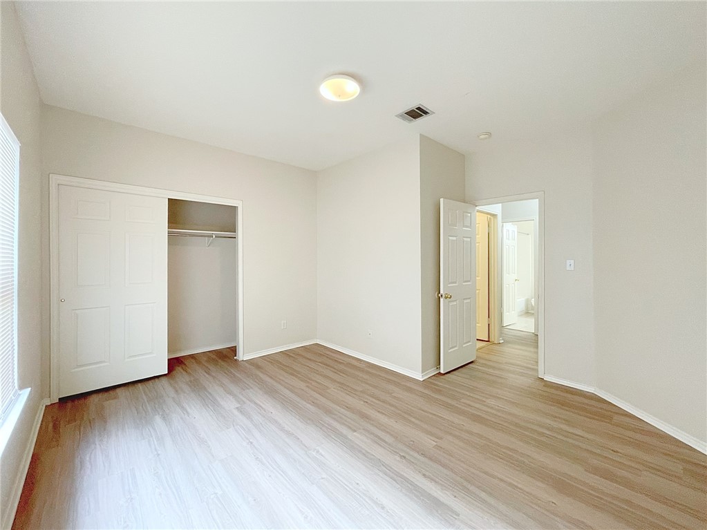 2211 Little Tree Bend Cedar Park, TX 78613 - Photo 18 of 23 a view of an empty room with wooden floor and a window