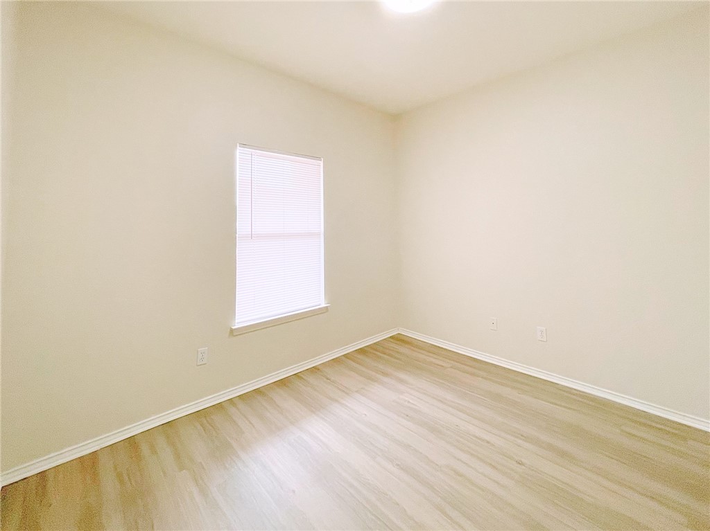 2211 Little Tree Bend Cedar Park, TX 78613 - Photo 19 of 23 a view of an empty room with wooden floor and a window