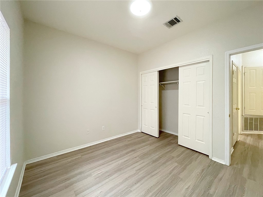 2211 Little Tree Bend Cedar Park, TX 78613 - Photo 20 of 23 an empty room with wooden floor and closet