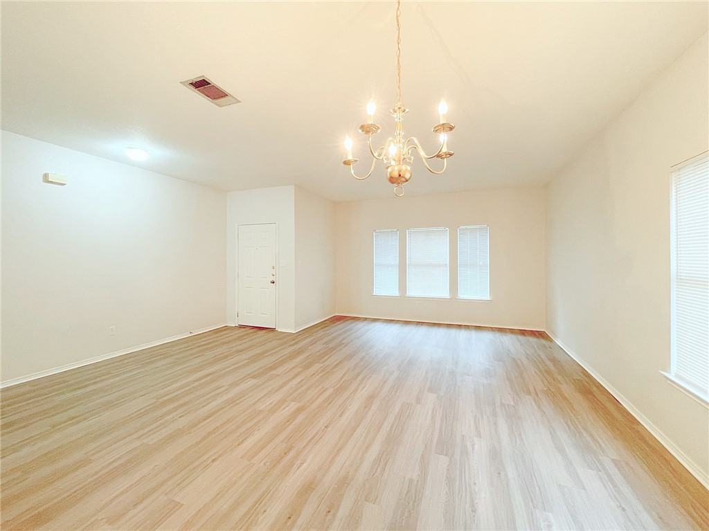 2211 Little Tree Bend Cedar Park, TX 78613 - Photo 3 of 23 wooden floor in an empty room with a window