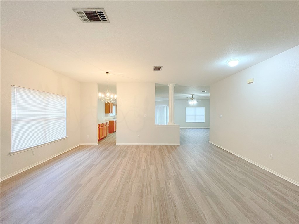 2211 Little Tree Bend Cedar Park, TX 78613 - Photo 4 of 23 an empty room with wooden floor and windows