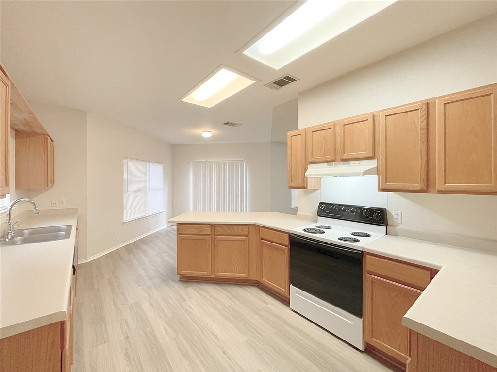 2211 Little Tree Bend Cedar Park, TX 78613 - Photo 7 of 23 a kitchen with stainless steel appliances granite countertop a stove a sink and a refrigerator