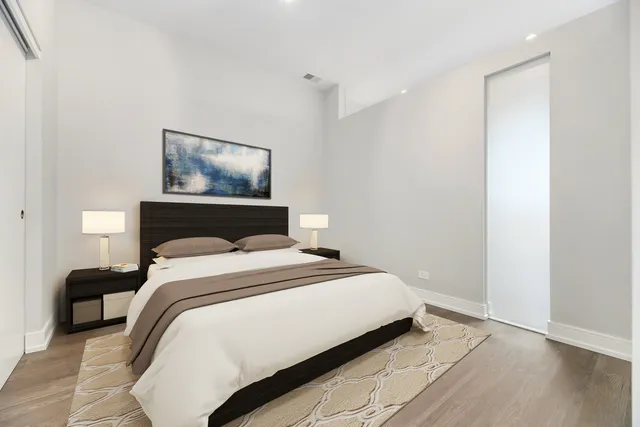 a bedroom with a bed and a painting on the wall