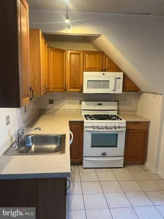 a kitchen with a stove a sink and a microwave