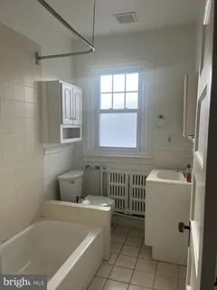 a bathroom with a bathtub and window