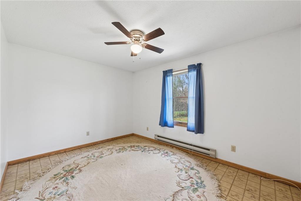 136 Bottom Road Mill Run, PA 15464 - Photo 10 of 26 a view of a big room with wooden floor windows and chandelier fan