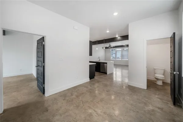 a view of a kitchen with refrigerator and cabinets