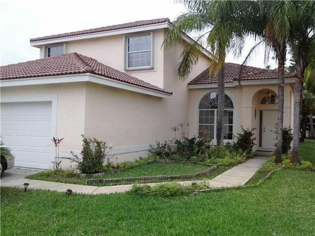 450 Southwest 182nd Way Pembroke Pines, FL 33029 - Photo 2 of 2 a front view of a house with a garden