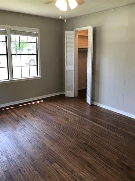 602 West 3rd Street Justin, TX 76247 - Photo 13 of 22 Interior room featuring wood-finish flooring, light grey walls, and white baseboards