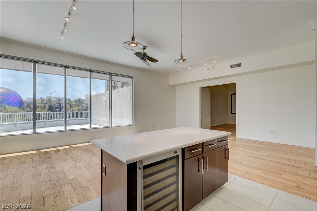 360 East Desert Inn Road, Unit 402 Las Vegas, NV 89109 - Photo 7 of 40 A contemporary open-concept space features panoramic windows and a central kitchen island.