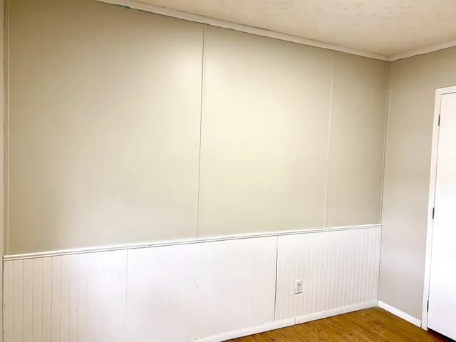 a view of a room with wooden floor