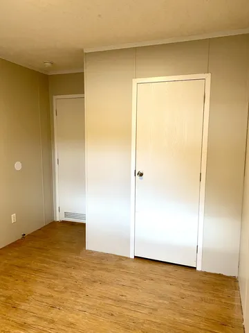 a view of a room with wooden floor