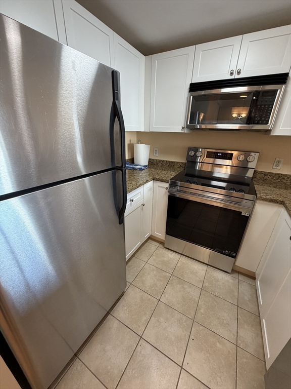 8 Museum Way, Unit 802 Cambridge, MA 02141 - Photo 11 of 39 a white refrigerator freezer and a stove sitting inside of a kitchen