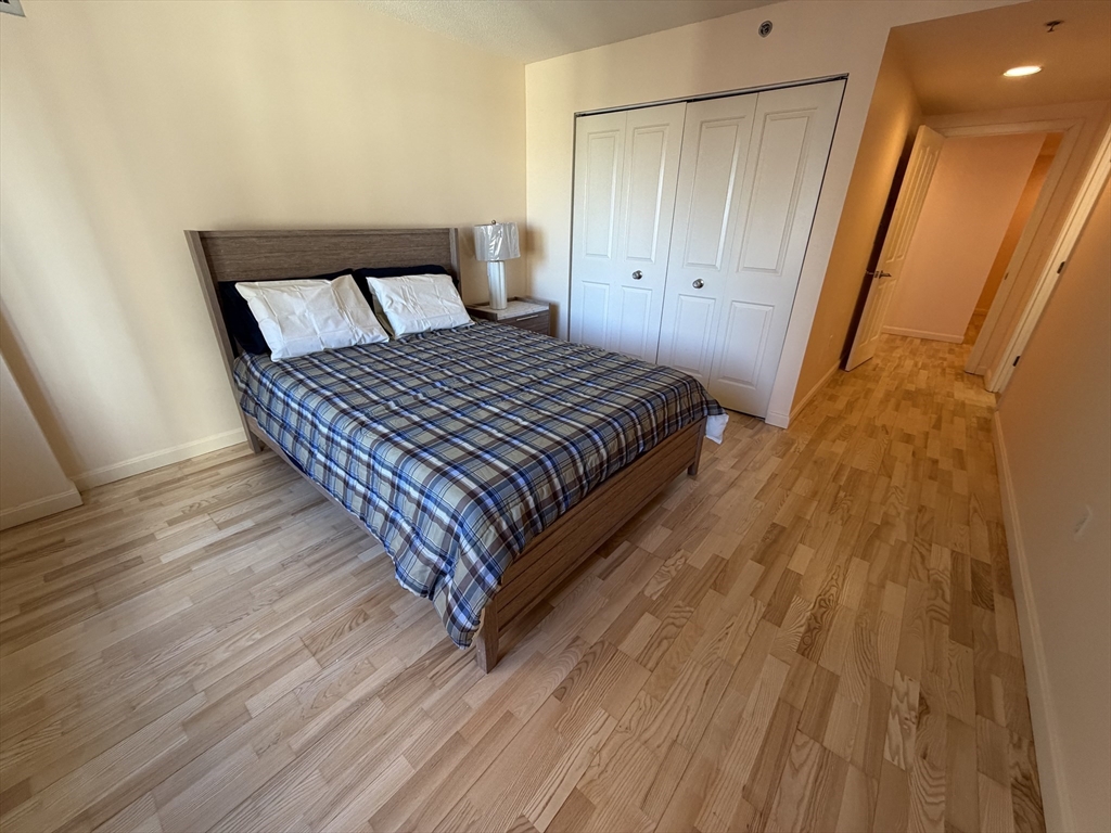 8 Museum Way, Unit 802 Cambridge, MA 02141 - Photo 13 of 39 a bedroom with a bed and wooden floor