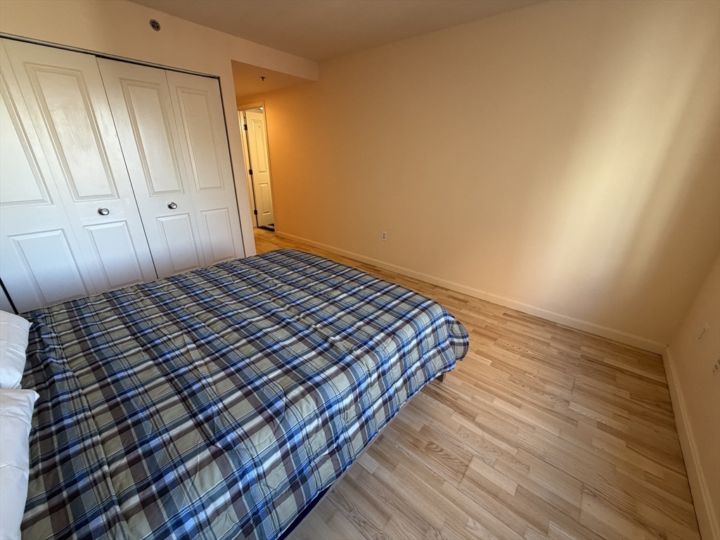 8 Museum Way, Unit 802 Cambridge, MA 02141 - Photo 15 of 39 a view of a bedroom with wooden floor