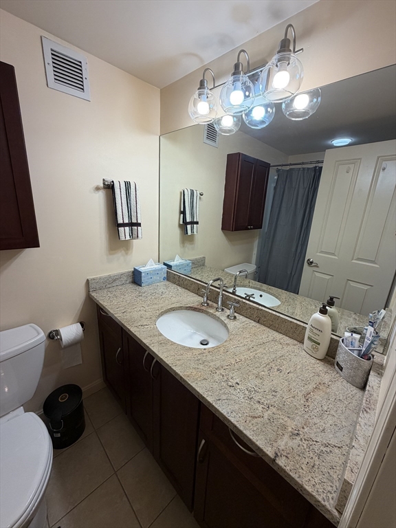 8 Museum Way, Unit 802 Cambridge, MA 02141 - Photo 17 of 39 a bathroom with a granite countertop sink a toilet and a mirror