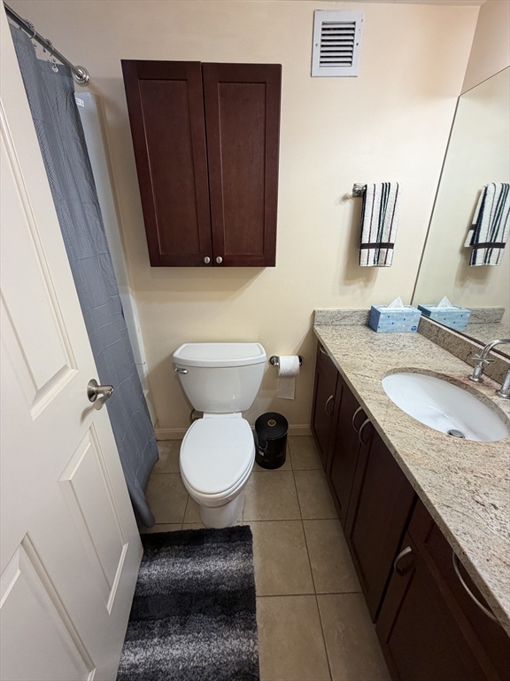 8 Museum Way, Unit 802 Cambridge, MA 02141 - Photo 18 of 39 a bathroom with a granite countertop toilet sink and mirror