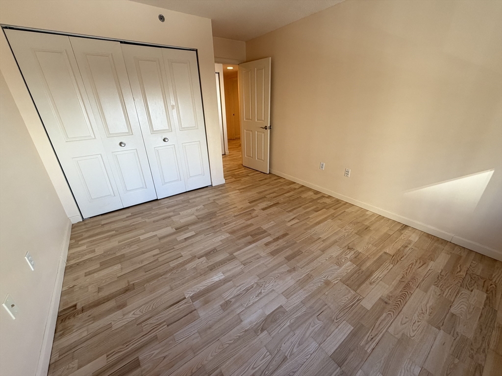 8 Museum Way, Unit 802 Cambridge, MA 02141 - Photo 19 of 39 a view of an empty room with wooden floor