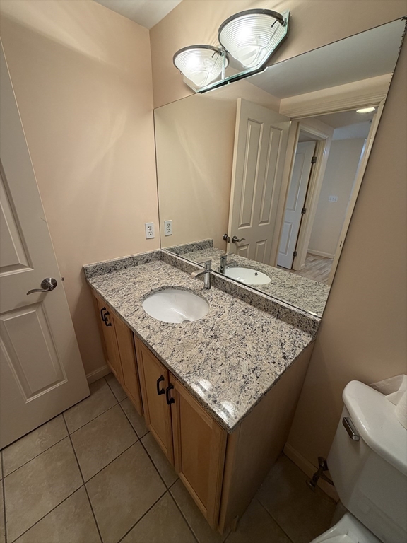 8 Museum Way, Unit 802 Cambridge, MA 02141 - Photo 23 of 39 a bathroom with a granite countertop sink and a mirror