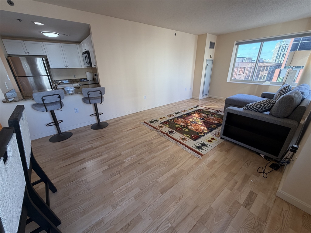 8 Museum Way, Unit 802 Cambridge, MA 02141 - Photo 3 of 39 a living room with furniture and a window