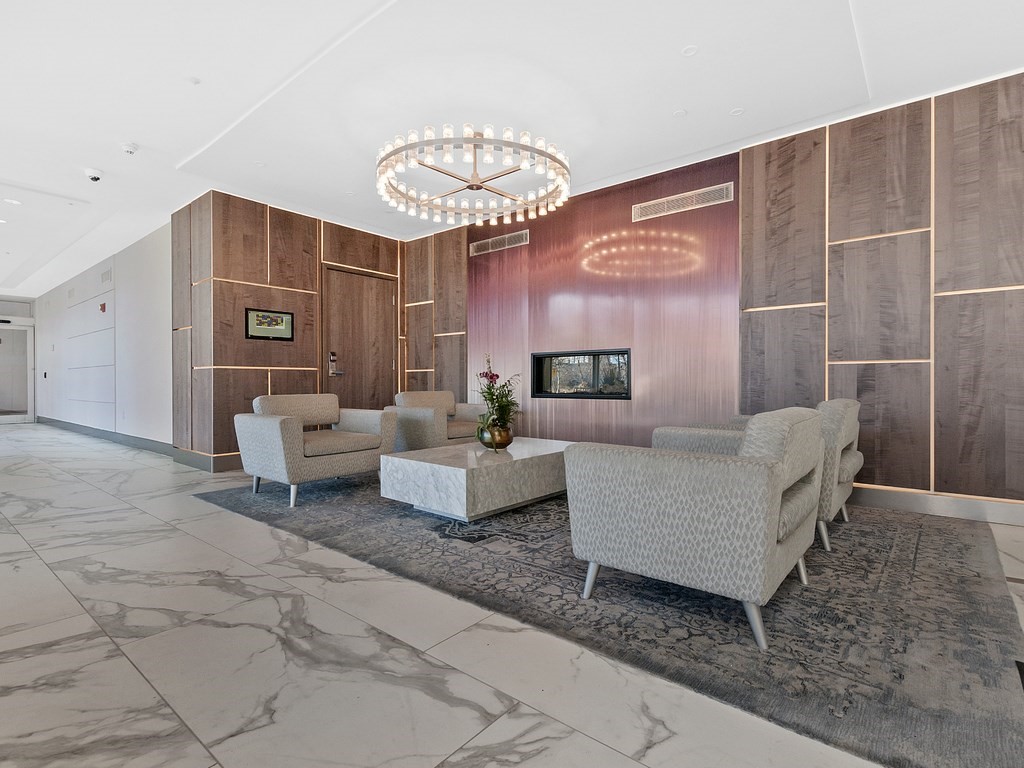 8 Museum Way, Unit 802 Cambridge, MA 02141 - Photo 33 of 39 a living room with furniture and a chandelier