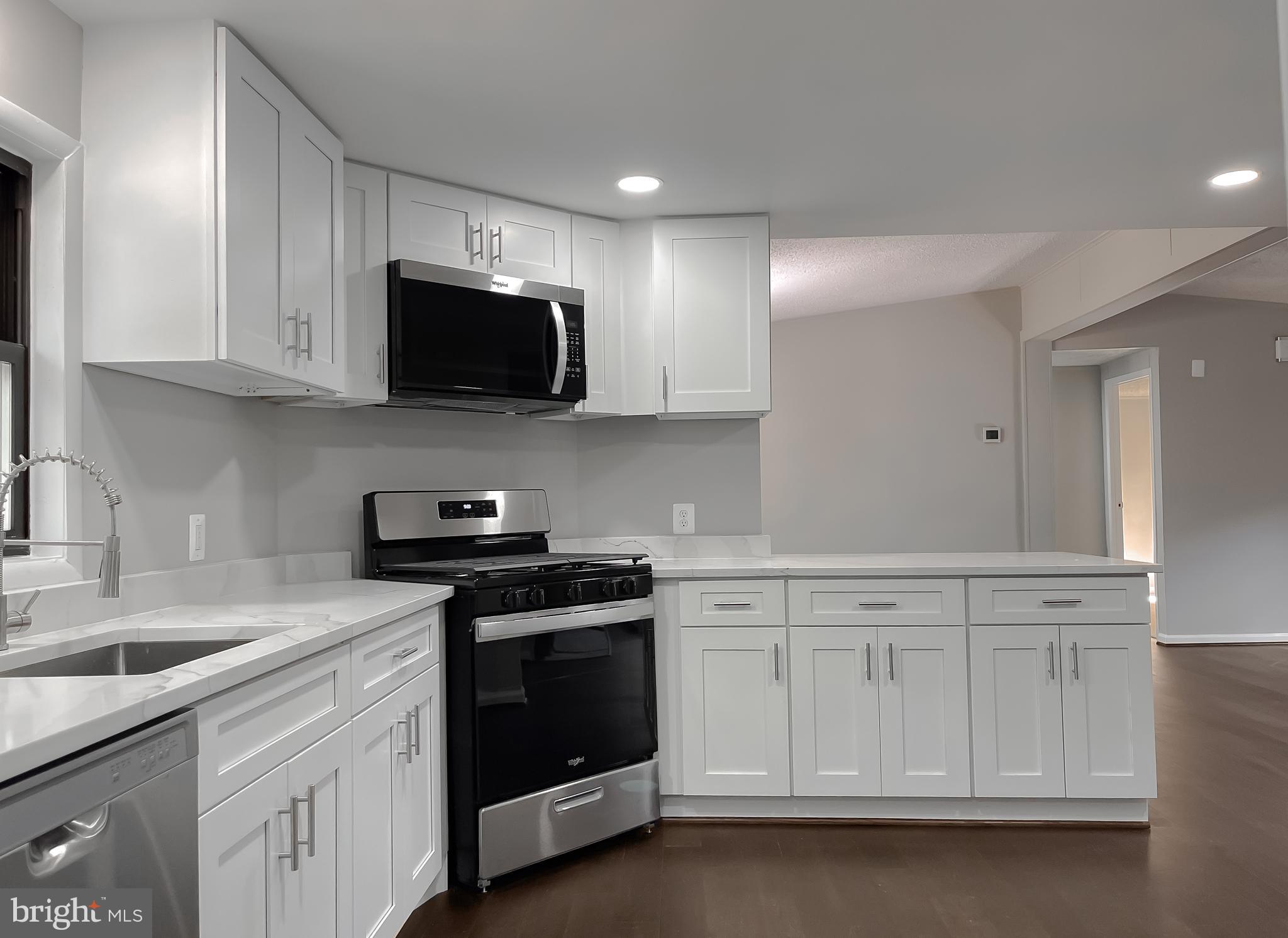 22489 Wainwright Court California, MD 20619 - Photo 11 of 41 a kitchen with white cabinets and stainless steel appliances