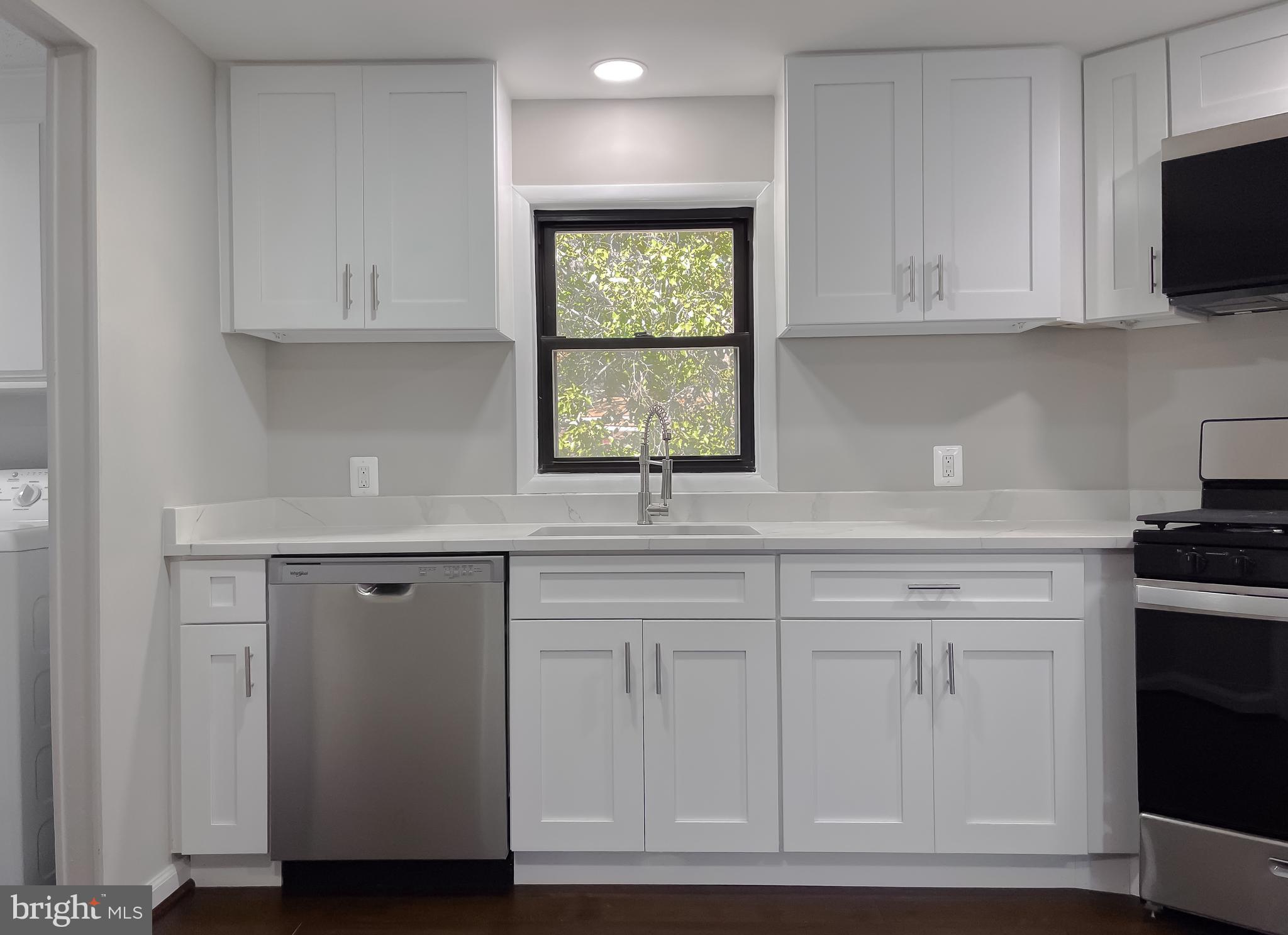22489 Wainwright Court California, MD 20619 - Photo 13 of 41 a kitchen with white cabinets and window