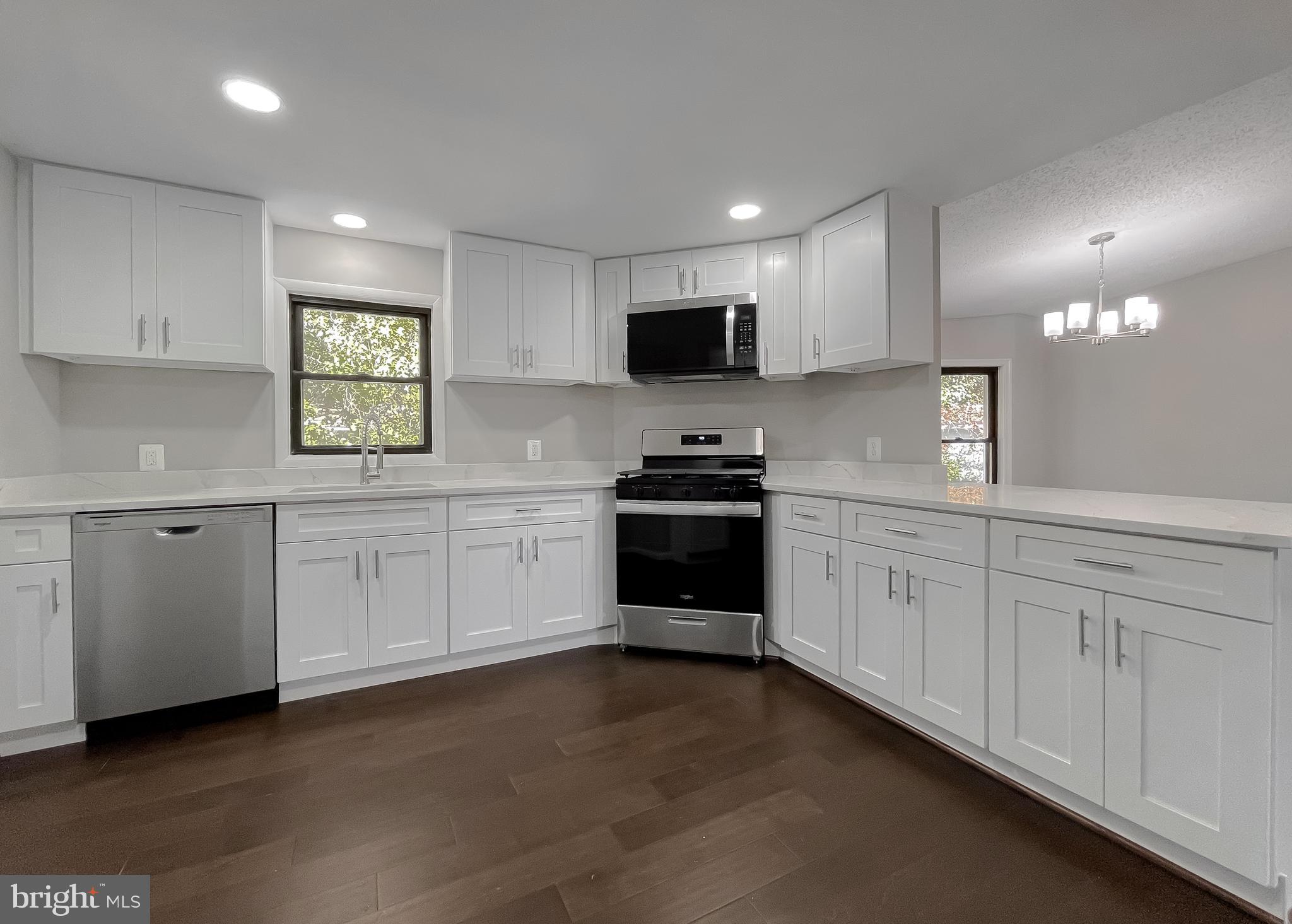 22489 Wainwright Court California, MD 20619 - Photo 14 of 41 a kitchen with white cabinets and appliances