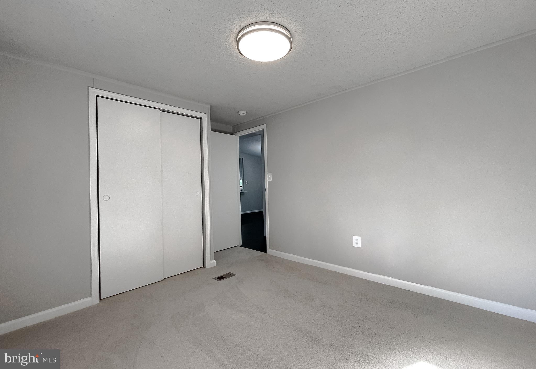 22489 Wainwright Court California, MD 20619 - Photo 18 of 41 an empty room with yellow lighting