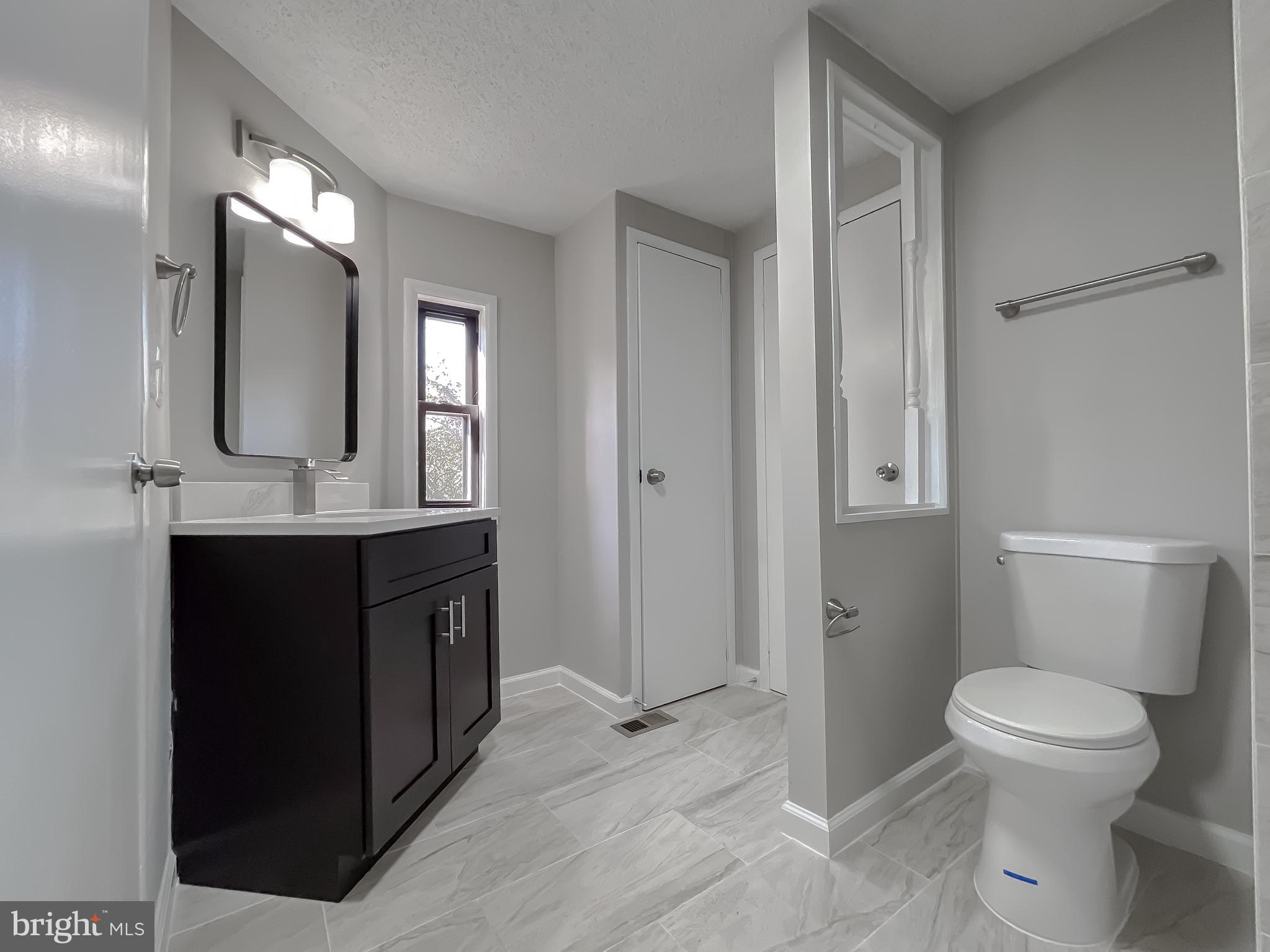 22489 Wainwright Court California, MD 20619 - Photo 32 of 41 a bathroom with a toilet sink and mirror