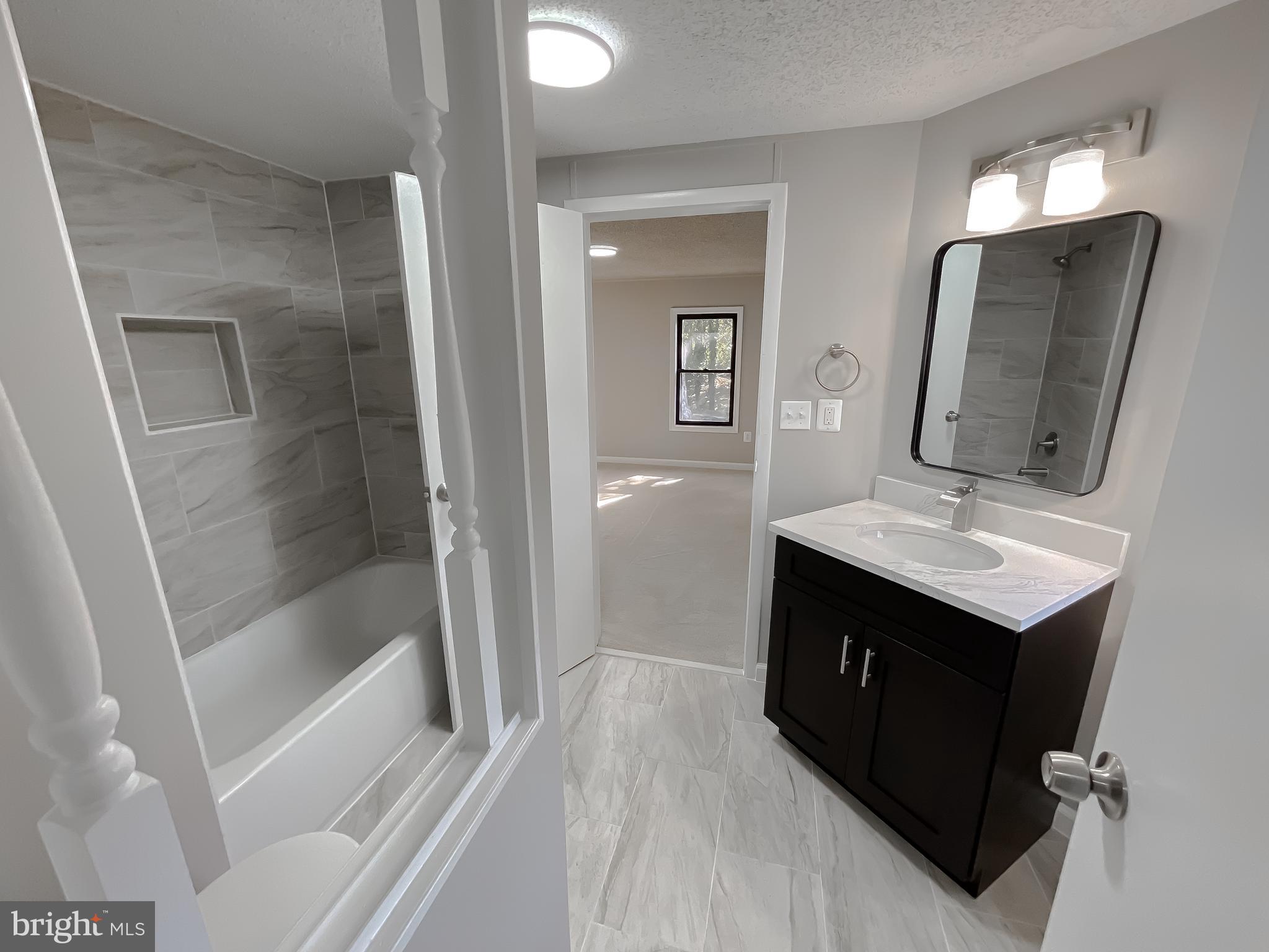 22489 Wainwright Court California, MD 20619 - Photo 34 of 41 a bathroom with a sink a mirror and a shower