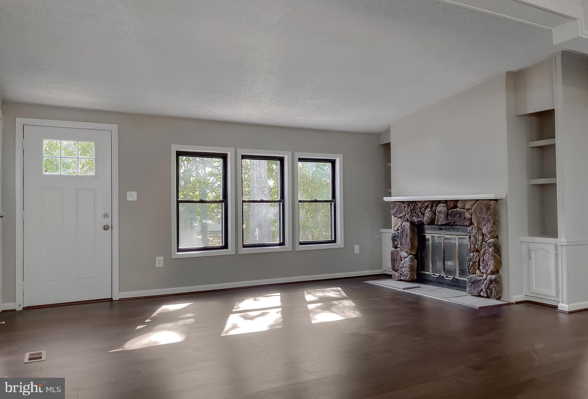 22489 Wainwright Court California, MD 20619 - Photo 7 of 41 an empty room with windows and fireplace
