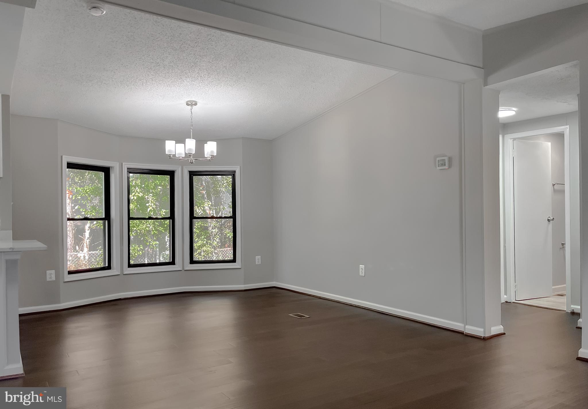 22489 Wainwright Court California, MD 20619 - Photo 9 of 41 an empty room with wooden floor and windows