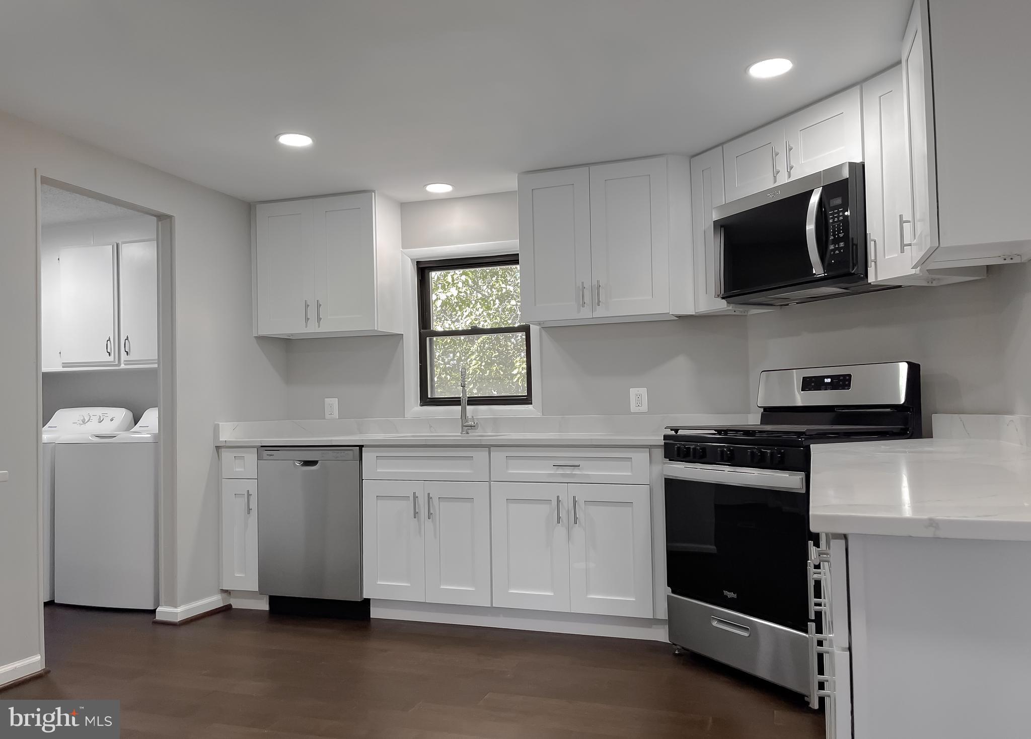 22489 Wainwright Court California, MD 20619 - Photo 10 of 41 a kitchen with stainless steel appliances granite countertop a stove a sink and a microwave