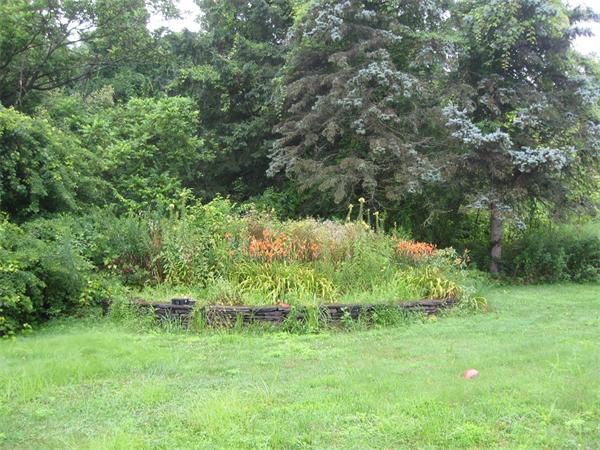 242 Florence Road Northampton, MA 01062 - Photo 14 of 16 a backyard of a house with lots of green space and garden