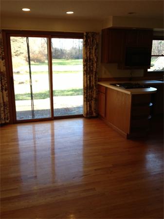 242 Florence Road Northampton, MA 01062 - Photo 5 of 16 a view of a living room with kitchen island wooden floor and a flat screen tv