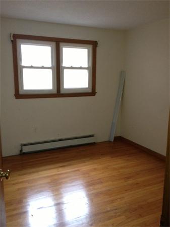 242 Florence Road Northampton, MA 01062 - Photo 10 of 16 a view of an empty room with wooden floor and a window