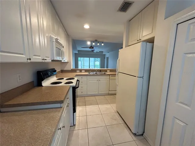a kitchen that has a sink and a stove in it