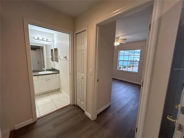 a view of bathroom with a toilet sink and mirror