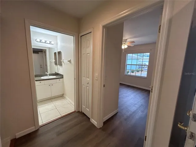 a view of bathroom with a toilet sink and mirror
